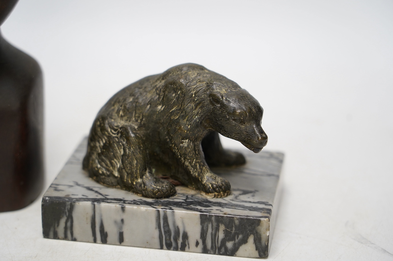 A bronze polar bear paperweight and an African tribal carved wood bust, 17cm high. Condition - fair, some splits to the bust